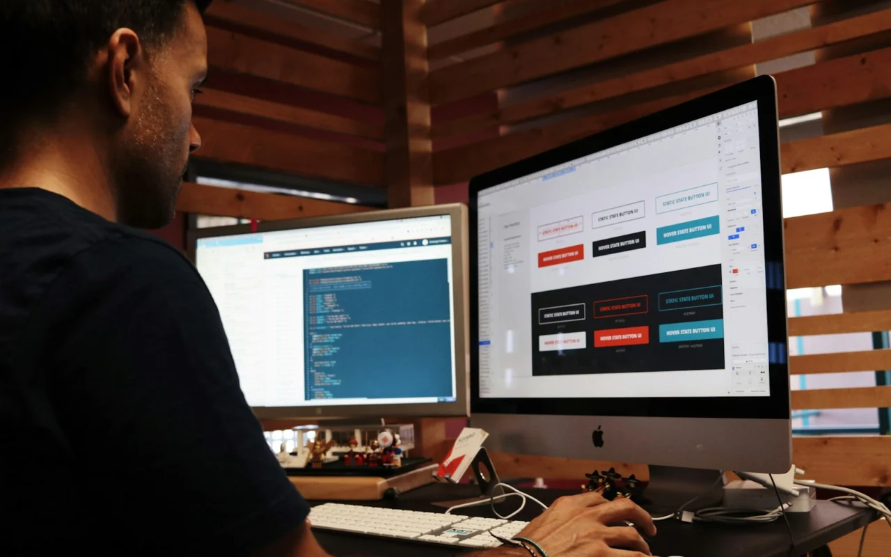 Designer reviewing a website layout on a desktop computer