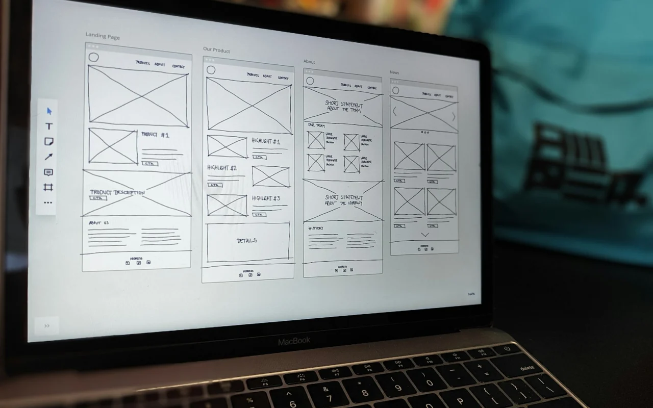 Website wireframe on a laptop screen on an office desk