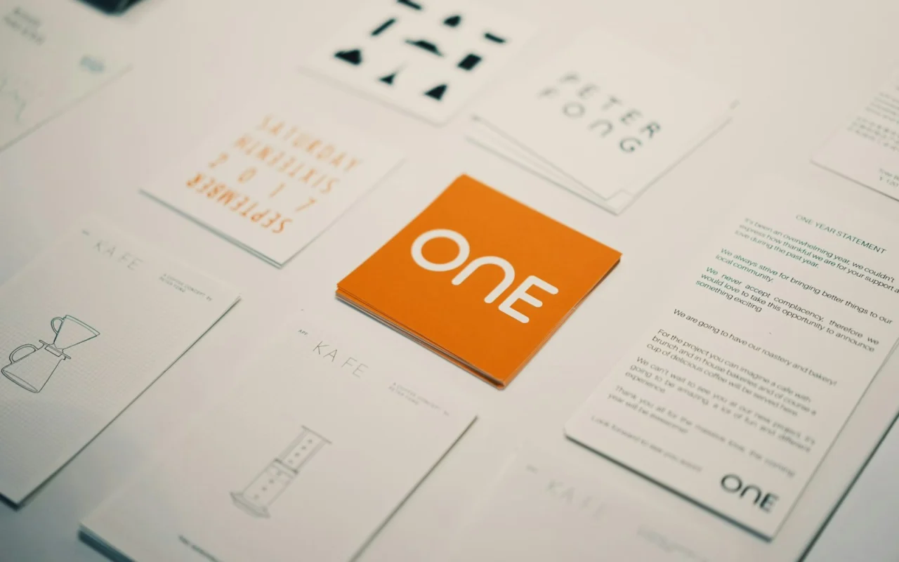 Orange brand card with a logo surrounded by other business cards
